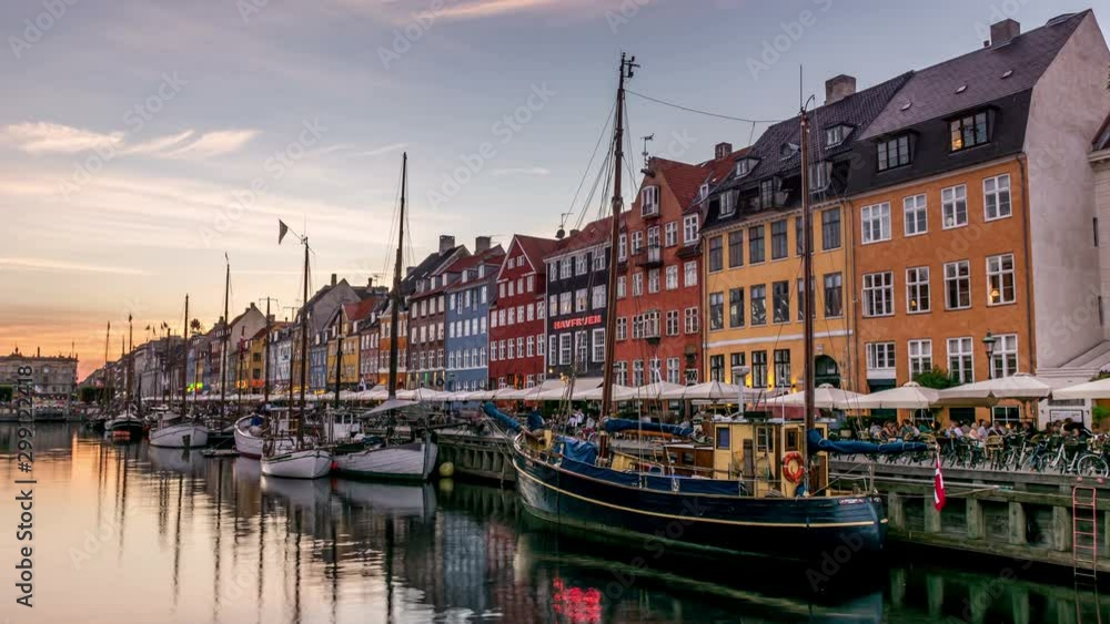 Nyhavn canal at dusk. It is one of the most iconic and most visited places in Copenhagen. Colorful house facades and sailing boats. Time lapse video. Nyhavn canal at dusk. It is one of the most iconic and most visited places in Copenhagen. Colorful house facades and sailing boats. Time lapse video.