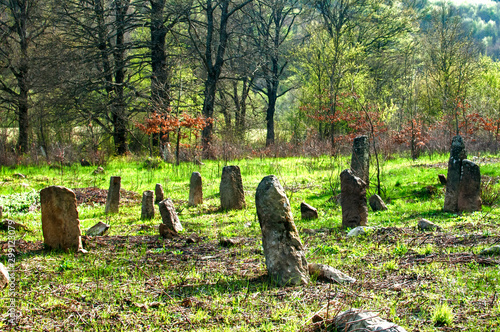 Scene of old abandoned Muslim cemetery tombstones in countryside field