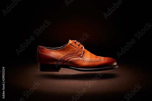 flying brown leather shoe