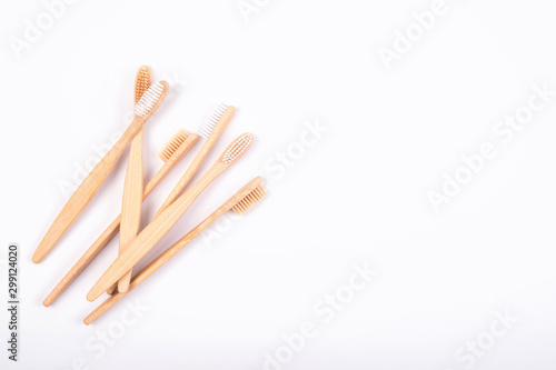 Top view of bamboo toothbrushes isolated on white background. Flat Lay. Zero waste eco life concept. Plastic free. Copy space.