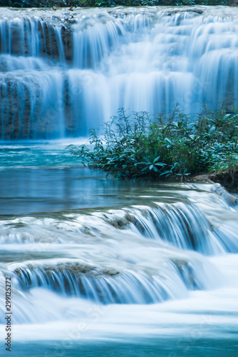 Relaxing by tropical waterfall in the morning.