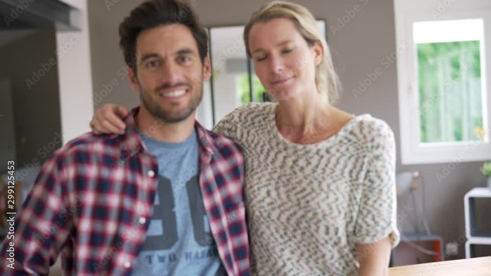 Young couple face camera inside the house Young couple face camera inside the house