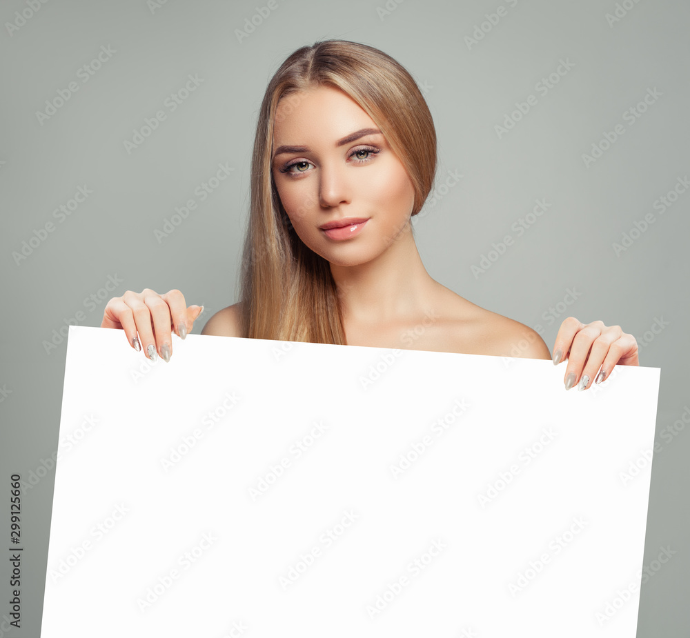 Young model woman with clear skin holding empty white card singboard Young model woman with clear skin holding empty white card singboard