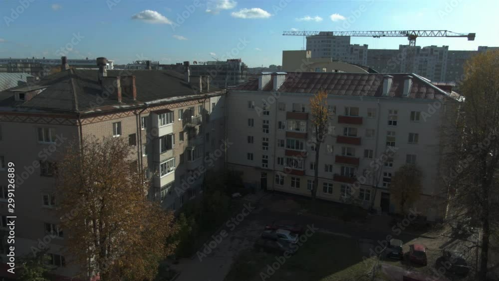 Old houses. Construction of the times of the USSR. House. Russia. Brick multi-storey building. Green trees. Beginning of autumn. Old houses. Construction of the times of the USSR. House. Russia. Brick multi-storey building. Green trees. Beginning of autumn.