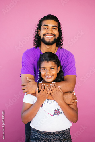 Portrait of an Afrolatinx young man and girl sibling in studio environment photo