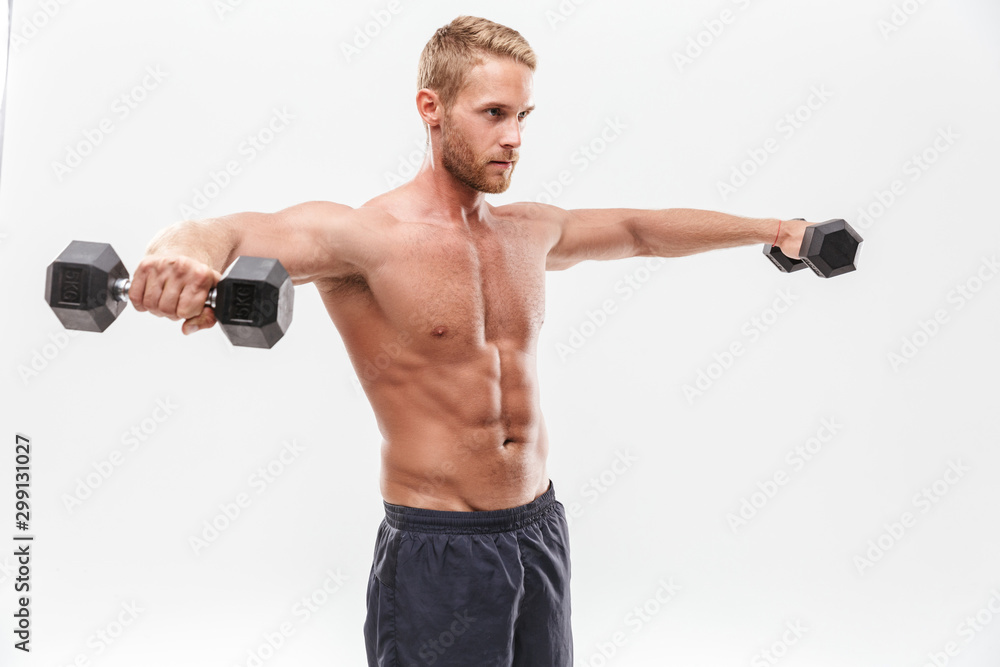 Confident attractive young muscular sportsman standing
