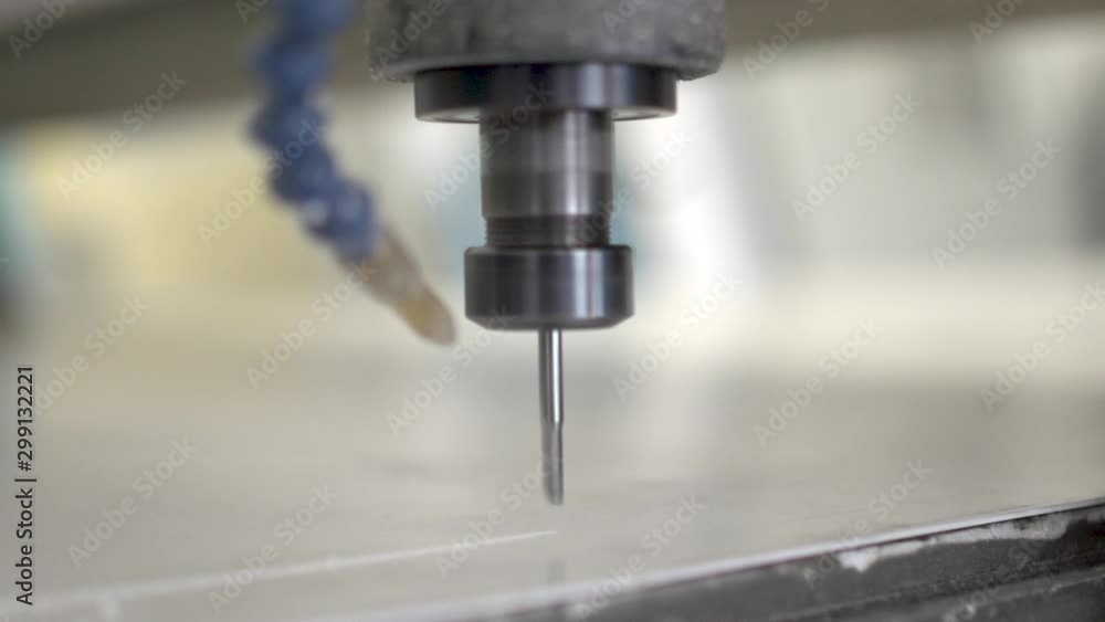 Close up of an end mill bit in action. Computer numerical control machine is getting started. Slow motion. Close up of an end mill bit in action. Computer numerical control machine is getting started. Slow motion.