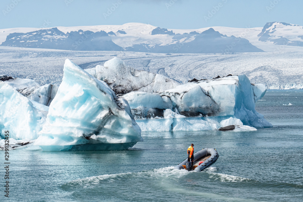 Naklejka premium The beautiful cold winter landscape of the Jokulsarlon glacier lagoon, Iceland, in the winter with snow-capped mountain as a background.