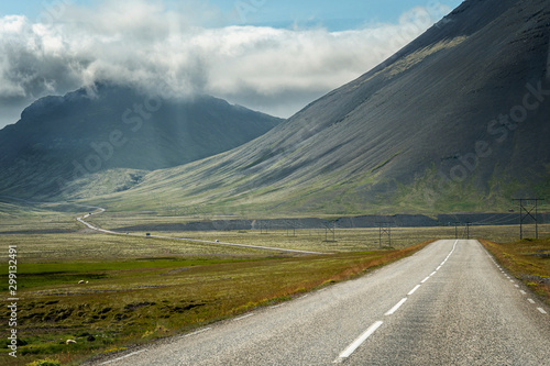 Iceland road landscape with clouds and amply field © bzzup