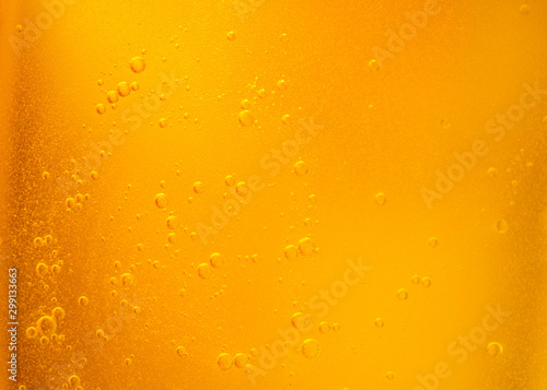 Bubbles on beer background. Oil drop shape on yellow background.Golden circle bubble water pattern.