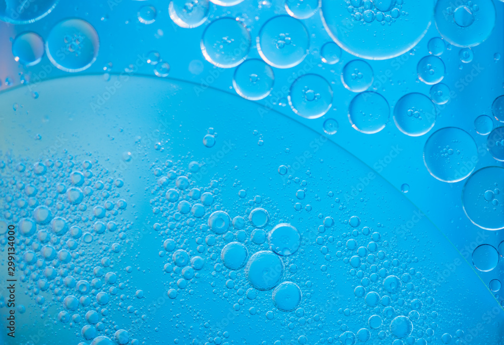 Air bubbles in the water background.Abstract oxygen bubbles in the sea.Circle foamy air in the ocean.Water bubbles isolate on blue background.