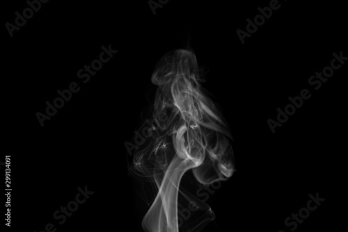 Movement of white smoke isolated on black background.Abstract shape and curve of smoke.