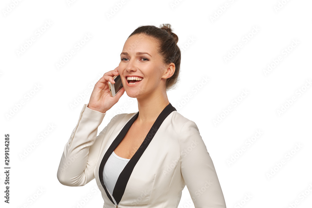 Business woman in a happy mood talking on a smartphone in a white jacket with her hair in a bun Business woman in a happy mood talking on a smartphone in a white jacket with her hair in a bun