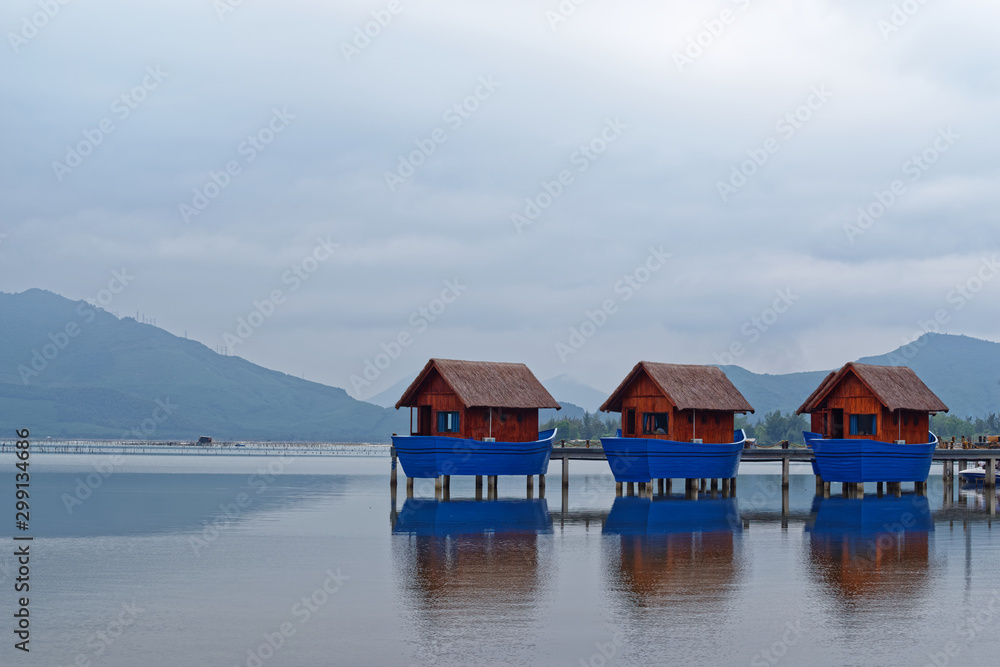 Romantic boat sheds on the shore in the lagoon of Lang Co, Vietnam Romantic boat sheds on the shore in the lagoon of Lang Co, Vietnam