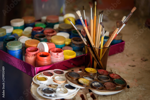 Artist’s brushes, paint cans and palette close-up
