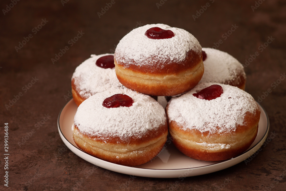 Tasty donuts with jam on wooden background - Hanukkah celebration concept .