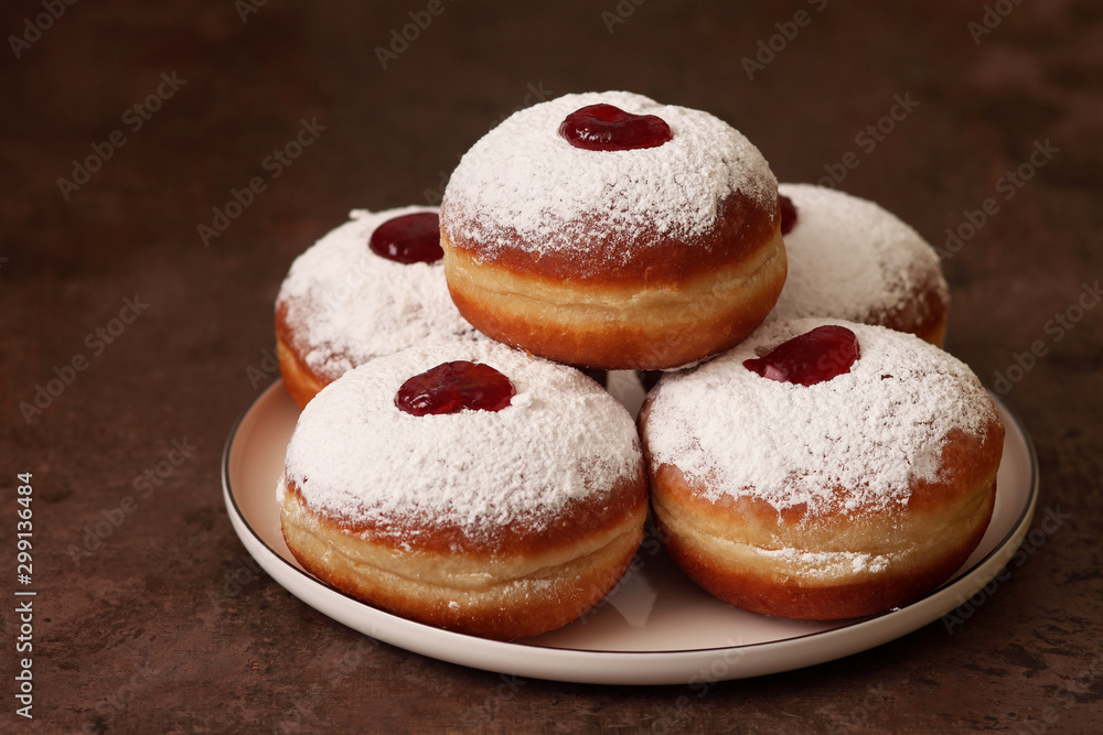 Tasty donuts with jam on wooden background - Hanukkah celebration concept . Tasty donuts with jam on wooden background - Hanukkah celebration concept .