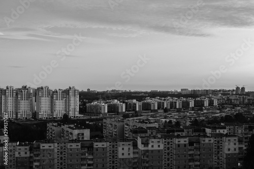 Panorama of a new standing area. The contrast of new and old houses. Black and white photo with soft contrast. Drama