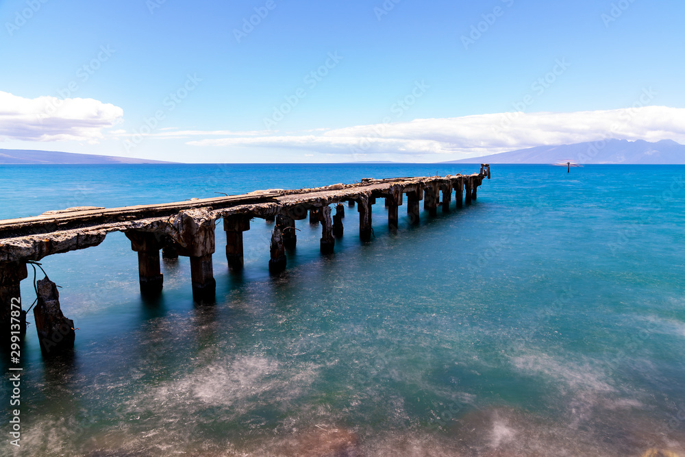 Old stone pier with mountain in Hawaii