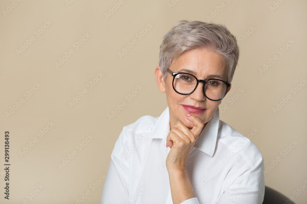 stylish beautiful woman with a short haircut, in a white shirt on a beige background stylish beautiful woman with a short haircut, in a white shirt on a beige background