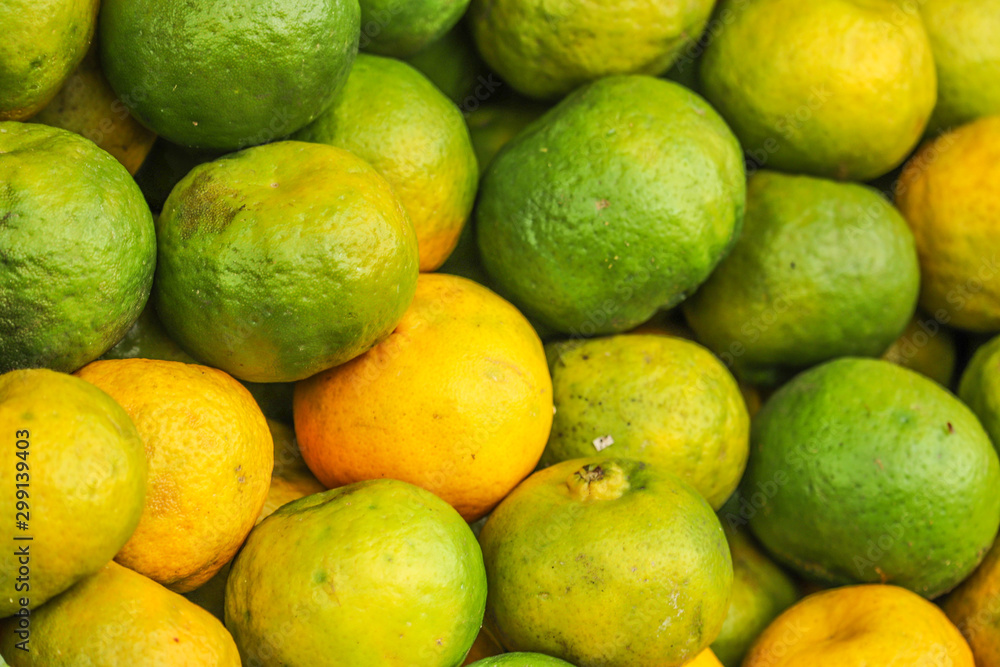 Heap Bunch of Oranges Fruit Fresh From Farm Yellow and Green Color in Market Decoration and Sale Heap Bunch of Oranges Fruit Fresh From Farm Yellow and Green Color in Market Decoration and Sale