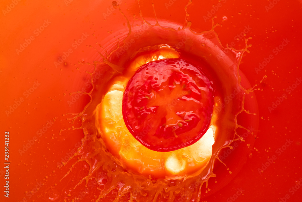 a piece of tomato dropped into tomato juice and a splash in the form of a window for text - obrazy, fototapety, plakaty 
