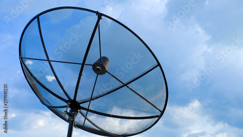 Black satellite dish on the blue sky background