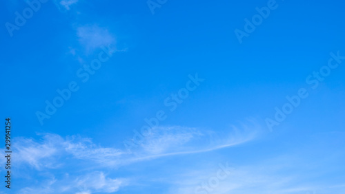 Blue sky background with tiny clouds © Thanasate
