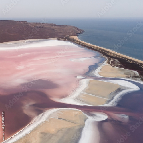 Pink Koyashskoye salt lake in Krym and Black Sea coast. Aerial view. Trendy coral color photo