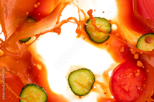 Fototapeta Naklejka Na Ścianę i Meble -  a piece of tomato, onion, cucumber dropped into tomato juice and a splash