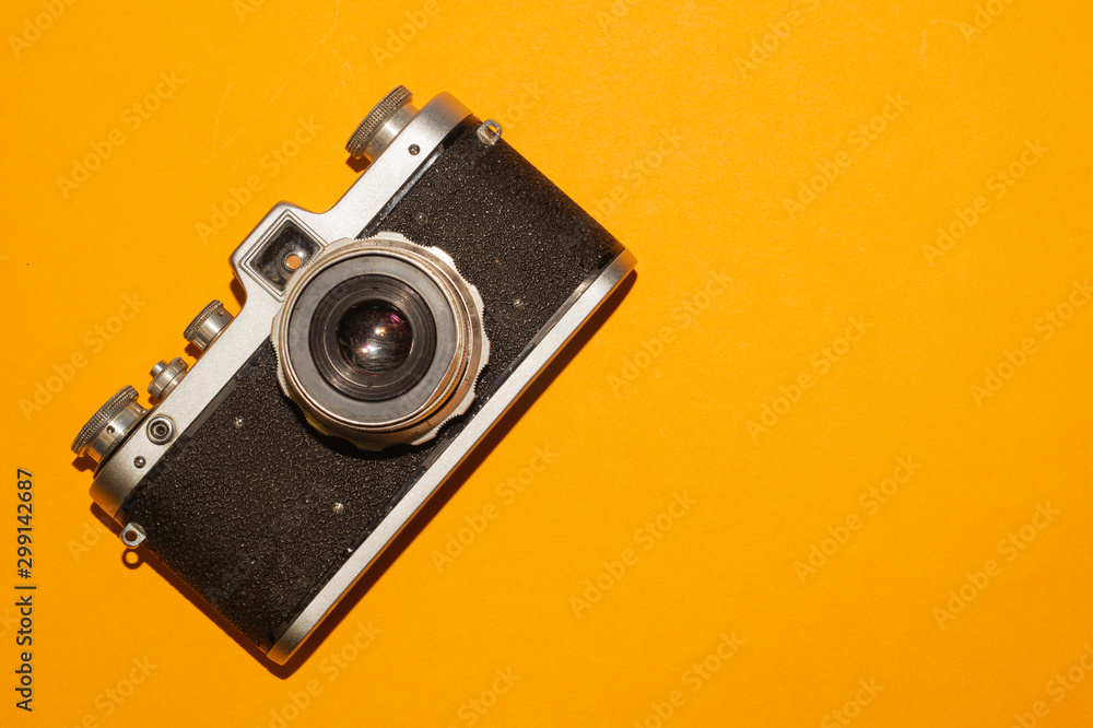 Analog camera on yellow background. copy space