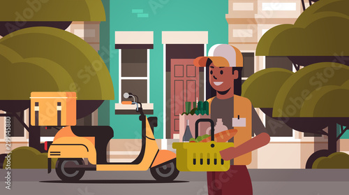 woman courier holding basket with groceries express food delivery from shop or restaurant concept modern house building exterior flat horizontal portrait vector illustration