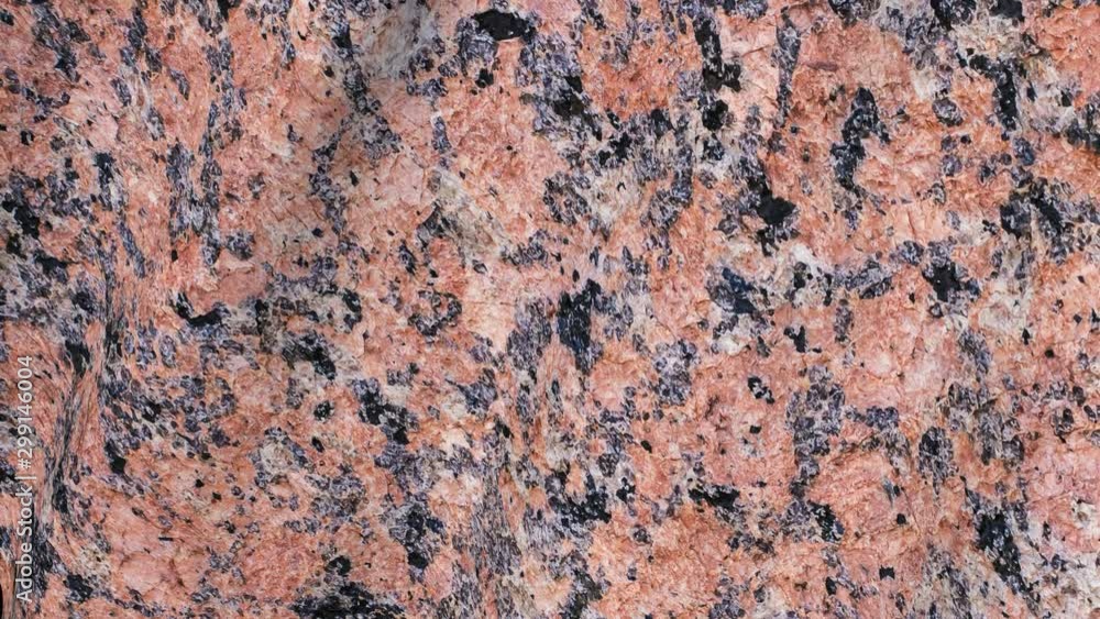 The surface texture of the red polished marble on the canvas. Abstract the motion of a rigid wall. The surface texture of the red polished marble on the canvas. Abstract the motion of a rigid wall.