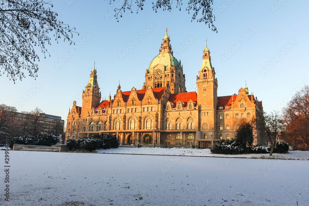 Obraz premium Panorama of the New town hall Rathaus and masch park in winter sunset in Hannover. There is frozen lake.