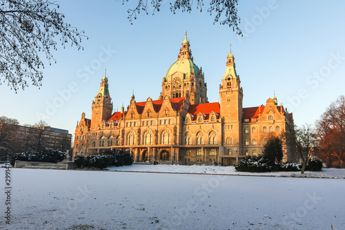 Panorama of the New town hall Rathaus and masch park in winter sunset in Hannover. There is frozen lake.