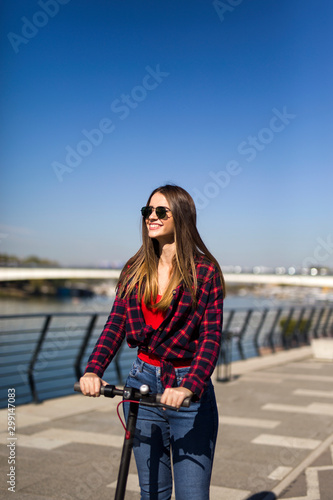 Pretty young woman riding a...