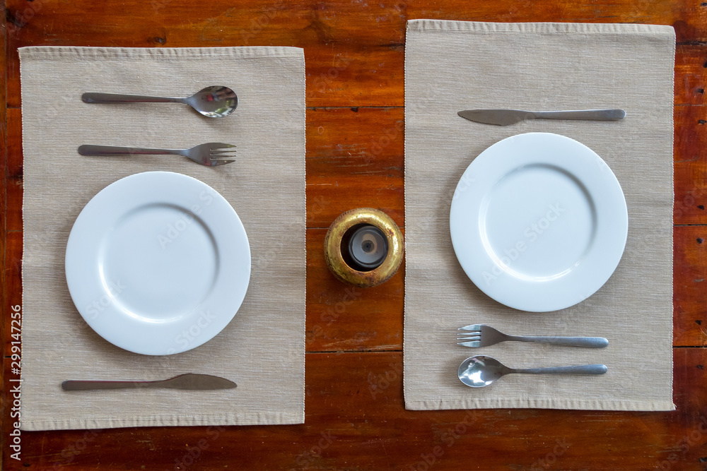Wooden table set for two with plates and candle holder Wooden table set for two with plates and candle holder