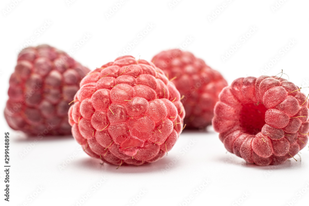 Group of five whole fresh crimson raspberry isolated on white background Group of five whole fresh crimson raspberry isolated on white background