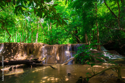 Waterfall in deep tropical rainforest with green tree