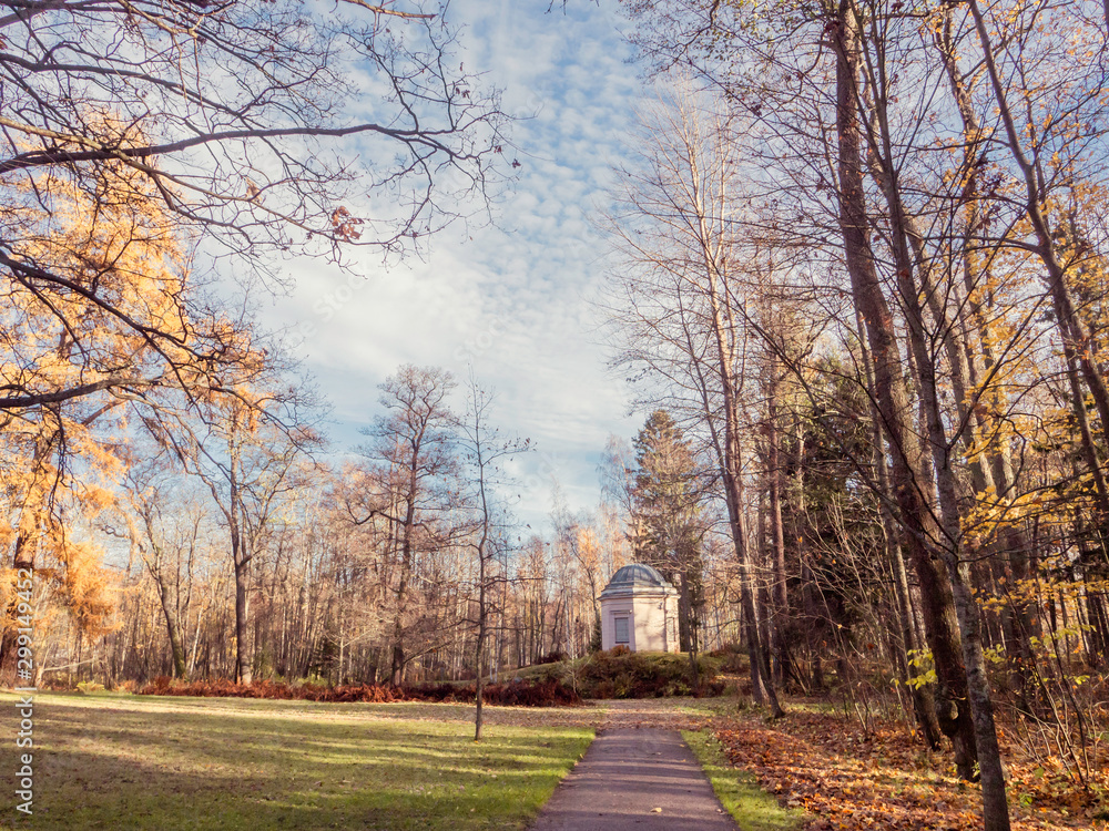 A footpath leading to a gazebo in a park in Helsinki, Finland, golden moment in the autumn nature