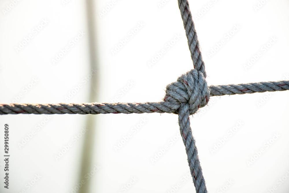 Mesh rope, sea rope fence, Tight knot is used for safety barrier net and  fishing net. Blurry background, abstract. Stock Photo