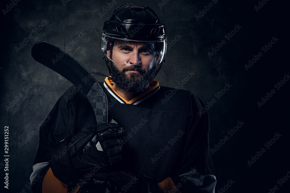 Serious pensive hockey player has a photo session at photo studio. Serious pensive hockey player has a photo session at photo studio.