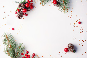 Christmas composition flatlay. Spruce branches, red berries on white background with space for text