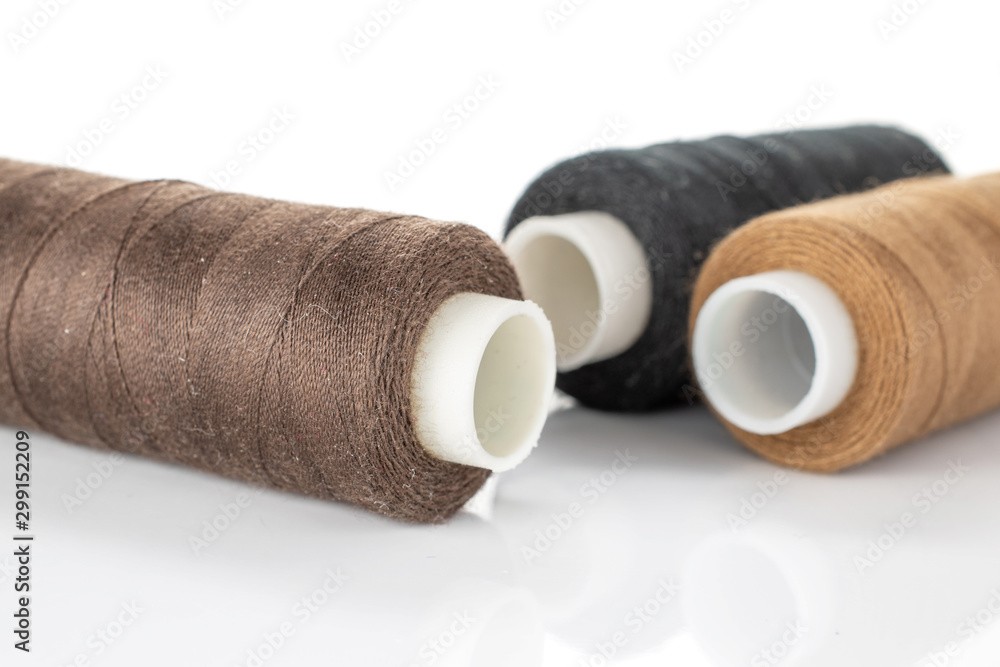 Group of three whole haberdashery item thread spools macro isolated on white background Group of three whole haberdashery item thread spools macro isolated on white background