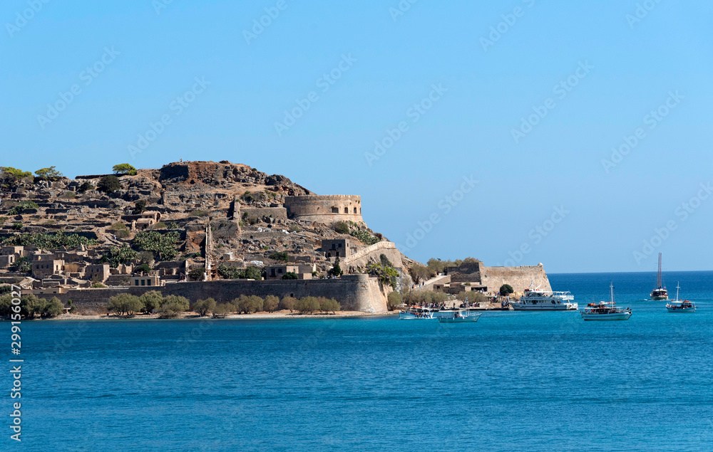 Spinalonga Island, Crete, Greece. October 2019. Ferries from Plaka and Elounda around the tiny harbour to transport tourists to visit this former leper colony.
