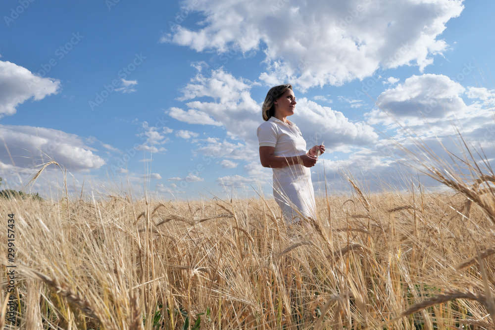 Girl in a white dress. In a wheat field. Girl in a white dress. In a wheat field.
