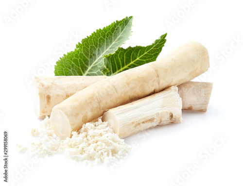 Horseradish with grated root in closeup on white background