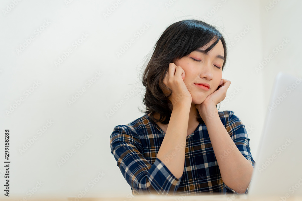 close up young employee japanese woman hand on chin to sleeping or napping in midday at office desk for healthy lifestyle people concept close up young employee japanese woman hand on chin to sleeping or napping in midday at office desk for healthy lifestyle people concept