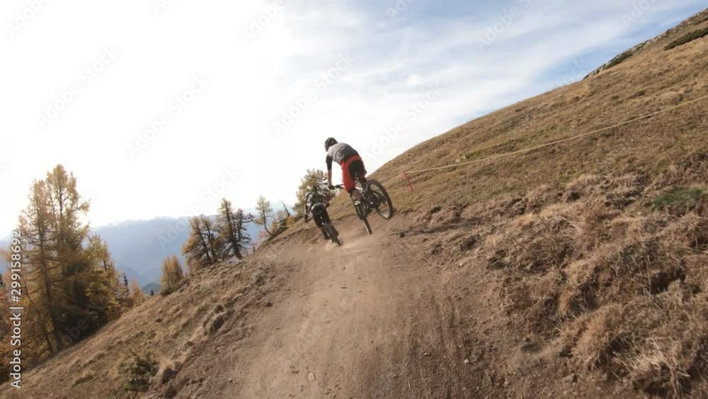 Following two bikers on a trail Following two bikers on a trail