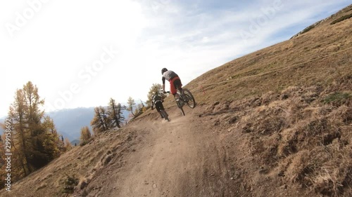 Following two bikers on a trail